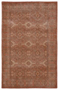 an orange and brown rug with geometric designs