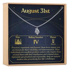 the zodiac sign necklace is displayed in a wooden box