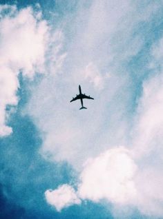 an airplane is flying high in the sky