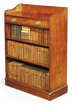 an old wooden bookcase with many books on it