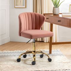 a pink office chair sitting on top of a wooden desk