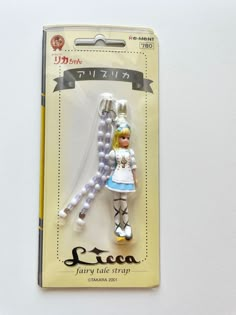 a white and blue doll is in the packaging for it's own keychain