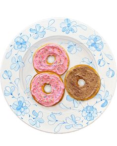 three donuts on a plate with blue flowers