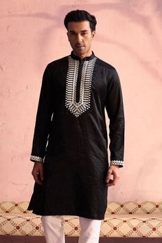 SHRESTHA BY VASTRAMAY Men's Black Silk Machine Embroidered Kurta Elegant and trendy, this black kurta features machine embroidery on the neckline. Made from a silk blend, it has a mandarin collar, long sleeves, and side slits for added comfort. Key Features Black silk blend with machine embroidery Mandarin collar Long sleeves Side slits Specifications Knee length Material & Care Top fabric: Silk blend Dry clean only Legal Disclaimer: The product is guaranteed to be 100% genuine. Product images a Black Long Sleeve Kurta For Festive Occasions, Casual Black Festive Kurta, Black Long Sleeve Festive Kurta, Traditional Black Long Sleeve Kurta, Black Long Sleeve Kurta With Chikankari Embroidery, Black Cotton Long Sleeve Kurta, Black Resham Embroidery Kurta For Festivals, Traditional Black Embroidered Kurta, Black Embroidered Kurta For Eid