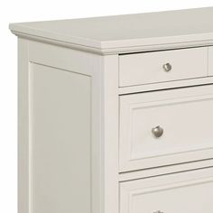 a white dresser with three drawers and two doors