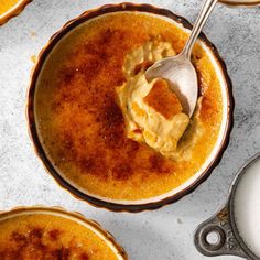 two bowls filled with food and a spoon