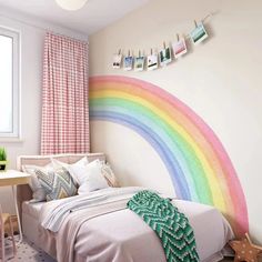 a bedroom with a rainbow painted on the wall