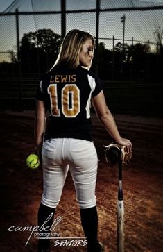 a softball player holding a bat and ball