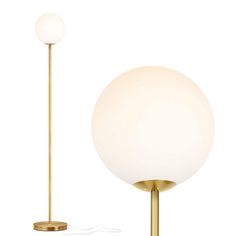 a white ball lamp sitting on top of a table next to a gold pole with a light bulb