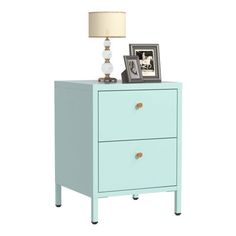 a blue nightstand with two drawers and a lamp on top of the side table next to it