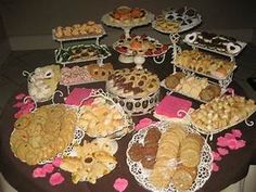 a table topped with lots of different types of pastries and desserts next to each other