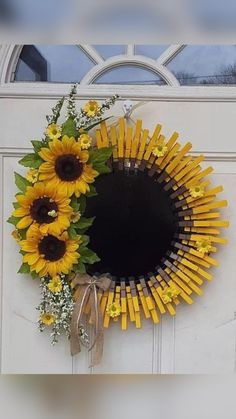 a sunflower wreath is hanging on the front door