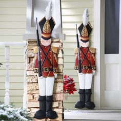 two nutcrackers are standing in front of a house