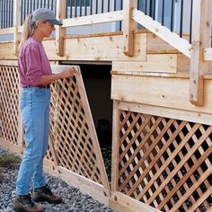 a man standing next to a wooden fence