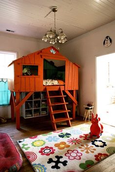 a child's bedroom with a loft bed and ladder to the second floor,