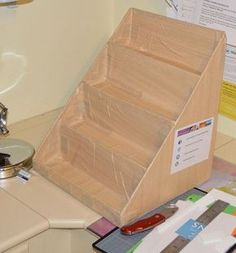 a wooden box sitting on top of a counter next to a knife holder and scissors