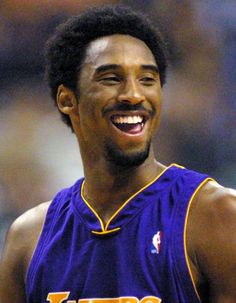 the los lakers's basketball player is smiling and looking at the camera