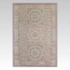 an antique rug with pink and beige colors