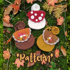 three crocheted purses sitting on top of a green grass covered ground with leaves