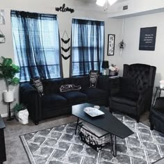 a living room filled with black furniture and windows