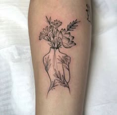 a black and white photo of a vase with flowers in it on the left arm