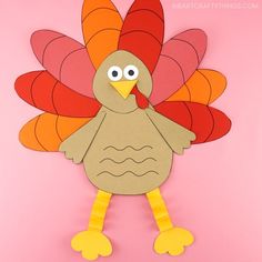 a paper turkey cut out on a pink background