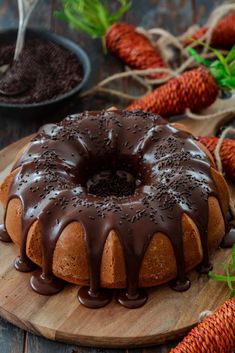 a bundt cake with chocolate icing on a wooden board