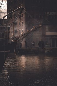 an old photo of people on a boat in the water near some buildings at night