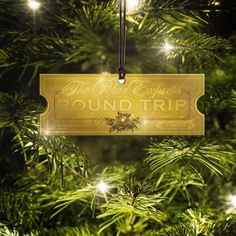 an ornament hanging from a christmas tree that says the best express round trip