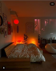 a bed room with a neatly made bed and some pictures on the wall above it