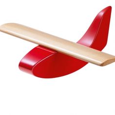 a red object with a wooden handle on it's back and one arm extended to the