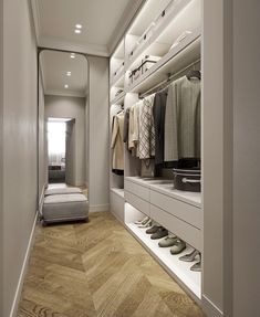 a walk in closet filled with lots of clothes