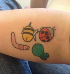 a ladybug, bee and turtle tattoo on the left arm by someone else