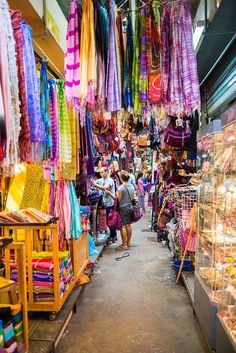 an outdoor market filled with lots of colorful items