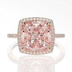 a fancy cushion cut pink diamond ring with pave diamonds on the shoulders and sides