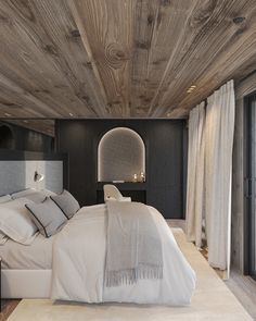 a large bed sitting under a wooden ceiling