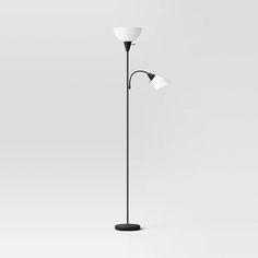 a black and white floor lamp with three lights