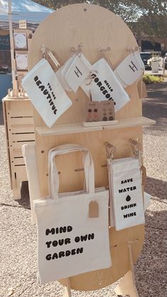 several bags are on display at an outdoor event with tags attached to them that say, save your own garden