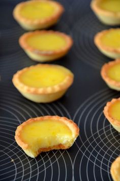 mini cheese pies are lined up on a cooling rack in the oven, ready to be baked