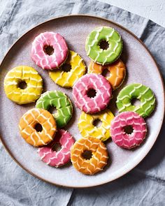 a white plate topped with donuts covered in frosting