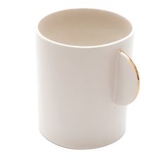 a white coffee cup with a gold handle