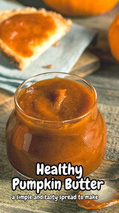 there is a small glass jar filled with pumpkin butter next to some slices of bread