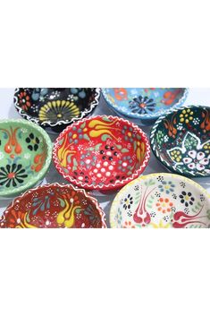 many colorful bowls with designs on them