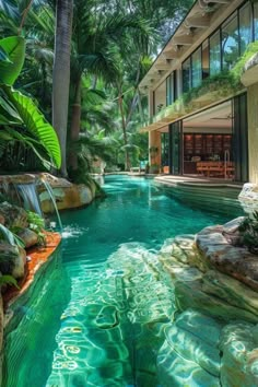 an outdoor swimming pool surrounded by palm trees and water features a waterfall in the middle