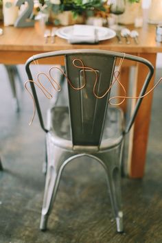 a chair that is sitting in the middle of a table with some writing on it