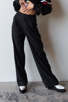 Meet your new favorite pants. Timeless and trendy are the Perfect Trouser featuring a loose fit with front pleat detail and side pockets. Color: Black Loose Fit Front Pleats Pockets Wide Leg Mid Rise Rayon Blend Model is 5'10", size 25/26 in bottoms and is wearing size small Baggy Wide-leg Dress Pants For Workwear, Black Relaxed Fit Pants For Office, Classic Black Cargo Pants For Work, Wide Leg Dress Pants With Side Pockets For Work, High Waist Baggy Dress Pants For Work, Classic Wide-leg Cargo Pants For Work, Relaxed Fit Pleated Pants With Tapered Leg, Pleated Relaxed Fit Tapered Leg Pants, Pleated Tapered Leg Pants With Relaxed Fit