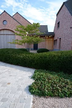 a brick house with a stone walkway leading to the front door