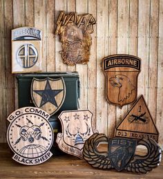 several wooden badges are displayed on a shelf in front of a wood paneled wall