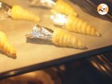 some food is being prepared on a baking sheet