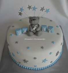 a baby shower cake with a teddy bear and stars on the top that says baby